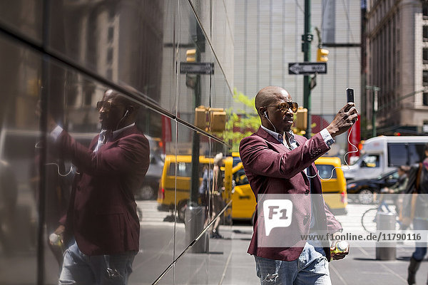USA  New York City  Manhattan  stylish businessman taking selfie with smartphone