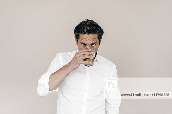 Businessman drinking from glass
