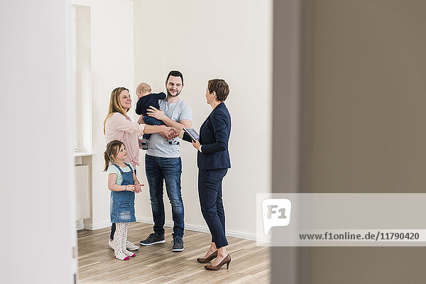 Real estate agent and family in new apartment