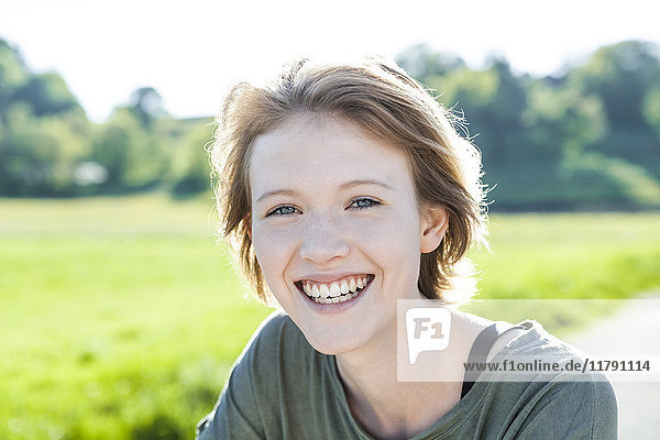 Porträt einer glücklichen jungen Frau in der Natur