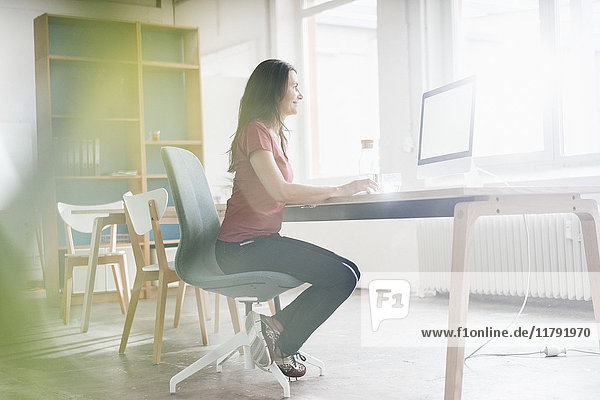 Woman working at desk in a loft