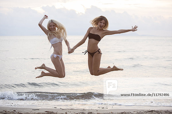 Two young women having fun on the beach