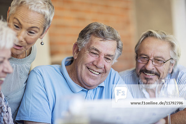 Portrait of smiling senior man having fun with his friends