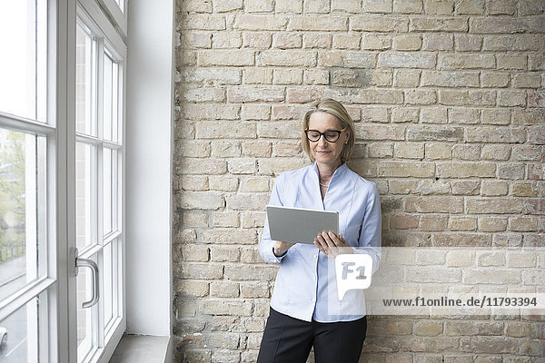 Mature businesswoman using digital tablet