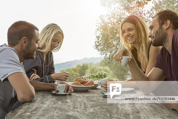Two couples having fun at breakfast table