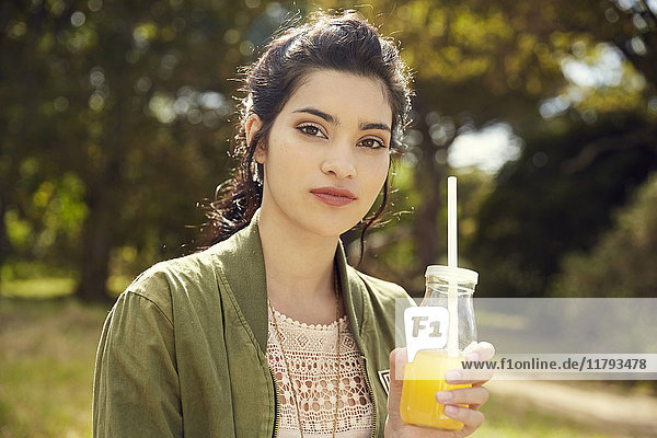 Porträt einer jungen Frau mit einem Glas Saft