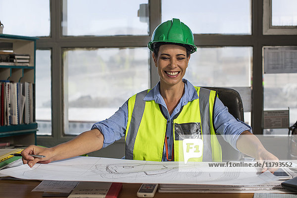 Female worker sitting in site office of quarry