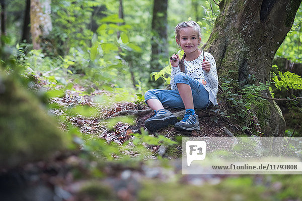 Portrait of smiling little girl in the woods
