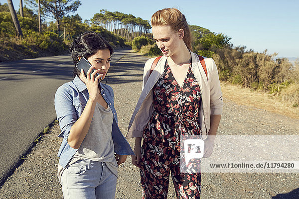 South Africa  Cape Town  Signal Hill  two young women with cell phone on a trip