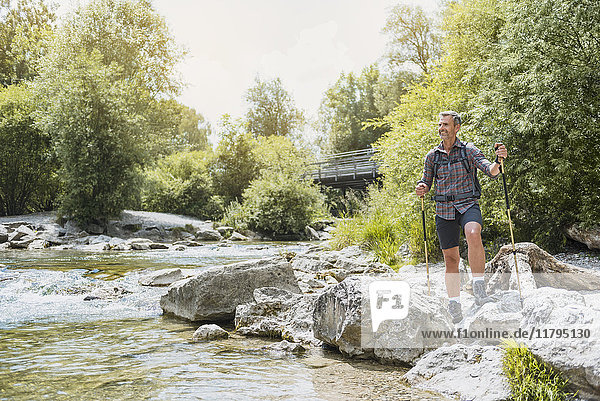 Hiker standing at the riverbank