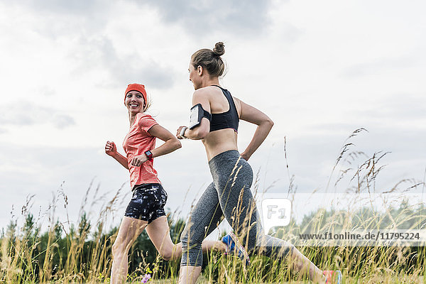 Two women running in the countryside