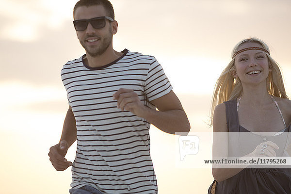 Junges Paar  das am Strand rennt