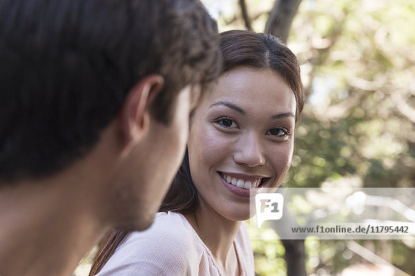 Young woman smiling at boyfriend
