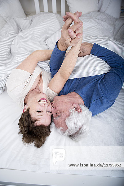 Senior couple having fun in bed
