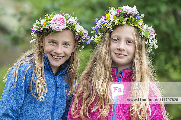 Smiling girls wearing flower wreaths