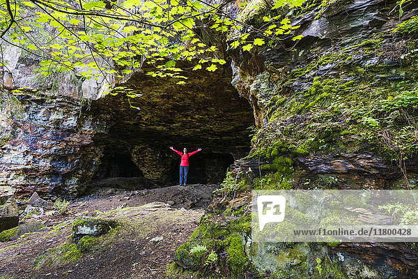 Hiker in front of cave