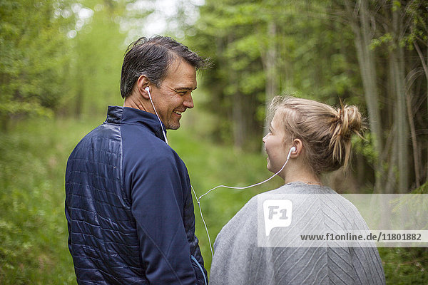 Father and daughter listening music