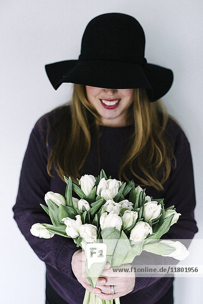 Lächelnde Frau mit weißen Tulpen