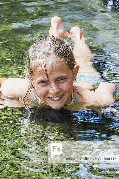 Porträt eines im Teich schwimmenden Mädchens