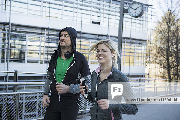 Man and woman jogging in city