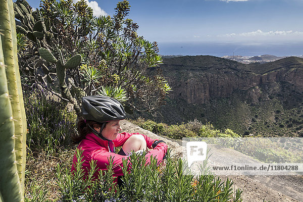 Tired mountain biker looking at distance