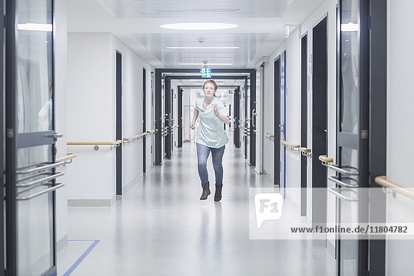 Nurse running in hospital hallway