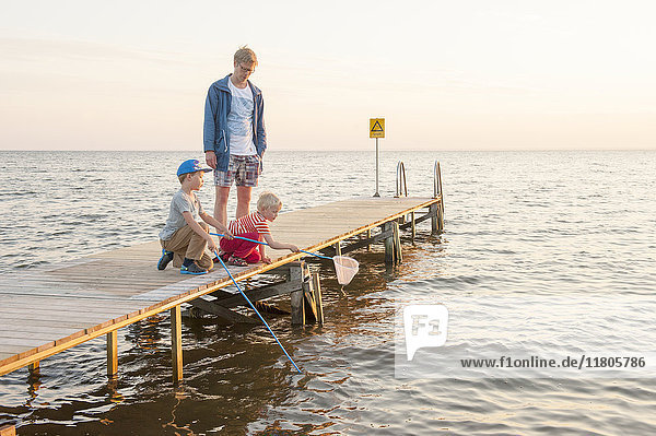 Father with sons on jetty