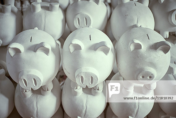 Pile of white piggybanks