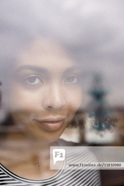 Smiling African American woman behind window