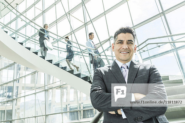 Portrait of businessman standing near staircase