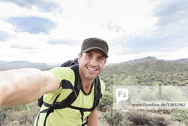 Hispanic man posing for selfie in desert