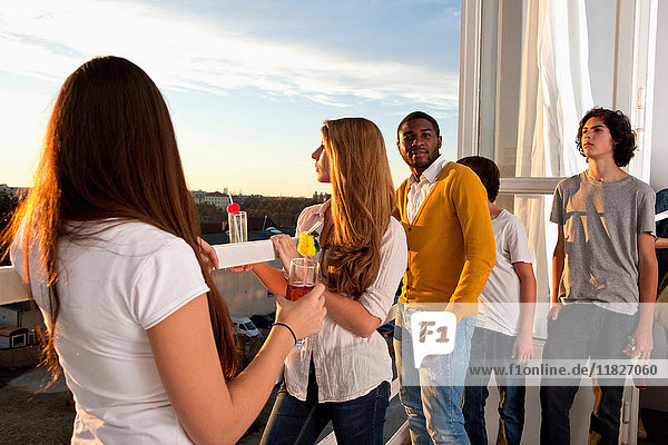 Group of friends at house party on balcony