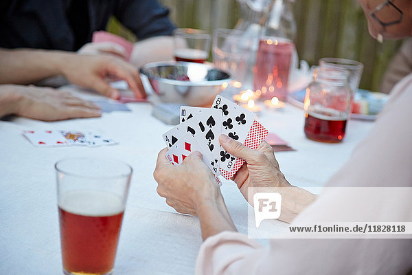 Freunde spielen Kartenspiel auf der Gartenparty