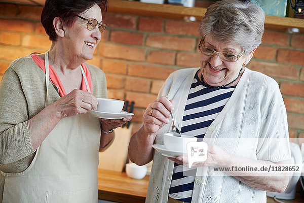 Senior adult women drinking coffee together