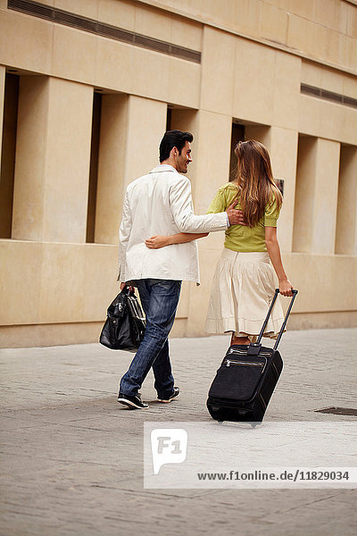 Couple walking with luggage
