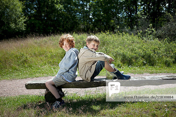 Children sitting on wooden bench