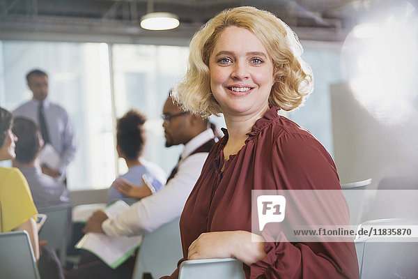 Portrait confident  smiling businesswoman in conference audience