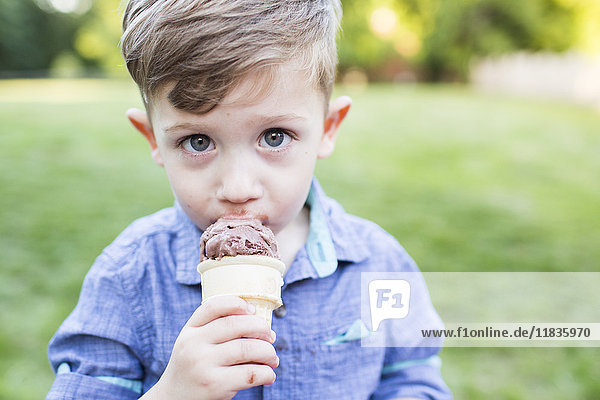 Portrait cute preschool boy eating ice cream cone