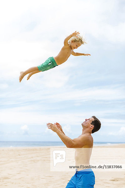 Vater mit Sohn (4-5) beim Spielen am Strand