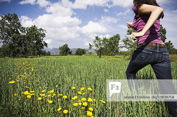 Mixed Race woman running in field