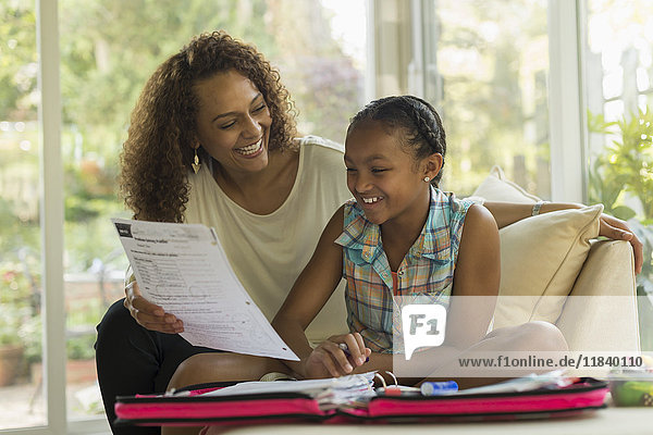 African American mother helping daughter with homework