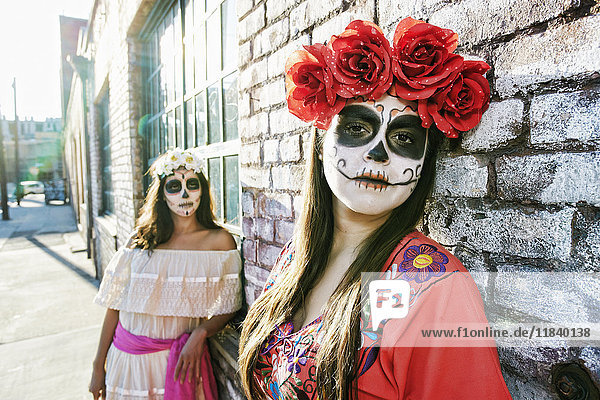 Frauen auf dem Bürgersteig mit Totenkopf-Gesichtsbemalung