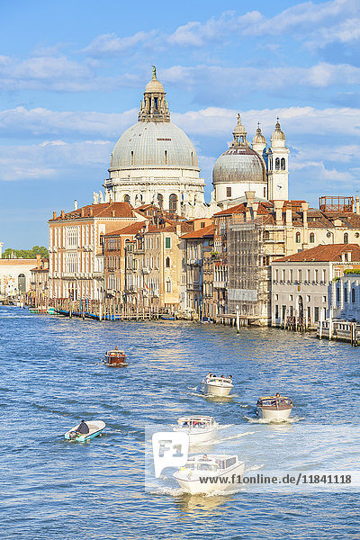Vaporettos (water taxis) passing the grand church of Santa Maria della Salute on the Grand Canal Venice UNESCO World Heritage Site Veneto Italy Europe