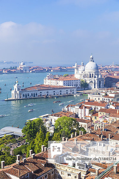 Vaporettos (water taxis)  rooftops and the church of Santa Maria della Salute  on the Grand Canal  UNESCO World Heritage Site  Venice  Veneto  Italy  Europe