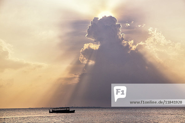 Dramatic cloud formations and boat in silhoutte at sunset Dhuni Kolhu Baa Atoll Republic of Maldives Indian Ocean Asia