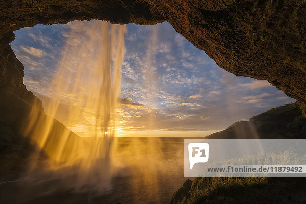 'Sunset light shines through the water of Seljandefoss along the South coast; Iceland'