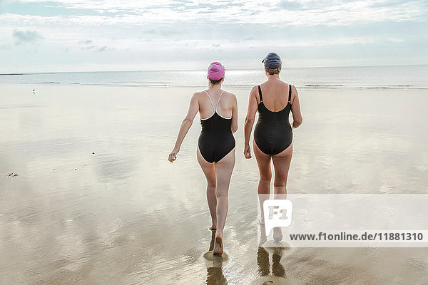 Mother and daughter heading to sea  Folkestone  UK