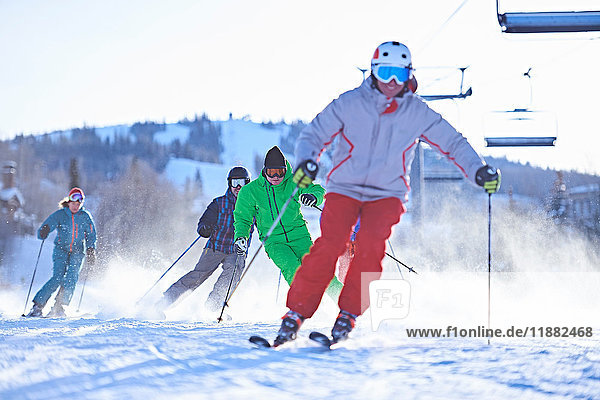 Male and female skiers skiing on snow covered ski slope  Aspen  Colorado  USA