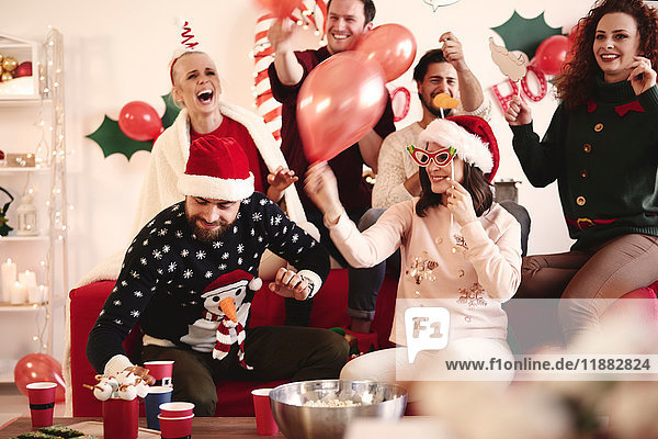 Young women and men having fun laughing at christmas party