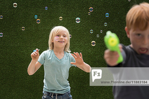 Boys using bubble maker